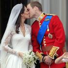 Britain's Prince William kisses his wife Kate, Duchess of Cambridge on the balcony of Buckingham...