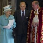 Britain's Queen Elizabeth II and her husband Prince Philip, centre, talk with the Dean of Windsor...