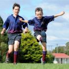 Brothers Josh (11), left,  and Ollie Mackenzie (7) have a kick around at the West Taieri rugby...