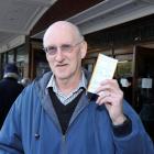Bruce Marshall, of Dunedin, flashes his reduced price Elton John concert tickets outside the...