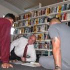 Otago Corrections Facility manager Sandy Stoddart listens to two prisoners participate in the Storybook for Dads programme. Photo by Glenn Conway.
