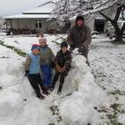 Building an igloo with the help of their father, Chris Horn, are (from left) Lochie (5), Holly (9...