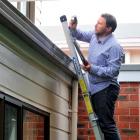 Building surveyor Gwynn Gilmour inspects the roof of a  Castle St flat yesterday. Photo by Craig...