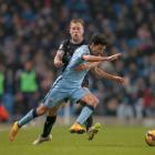 Burnley's Scott Arfield (rear) challenges Manchester City's Jesus Navas. REUTERS/Phil Noble