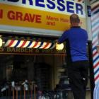 Business owner Selwyn Grave is less than impressed as Miller Studios signwriter Rob Harwood...