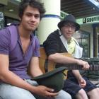 Buskers Dion Birch-Thompson and David Bell make the most of a break in the clouds to play a few...