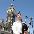 Busking performer Oliver Cathro plays the bagpipes outside the Dunedin Railway Station at 12.30pm...