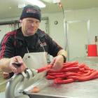 Butcher Shane Buchan makes special recipe sausages for tomorrow's  official opening of the second...