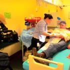 Cameraman Scott Mouat (left) films Dr Theresa Eckert as she treats Mike Harvey, of Waimate, for a...