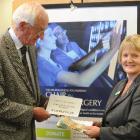 Campaign committee chairman Dr Brian McMahon hands over the latest donation to National Bank...