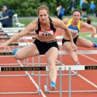 Canterbury hurdler Fiona Morrison leads Otago’s Christine Ashton to the final line in the senior...