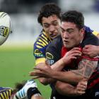 Canterbury's Codie Taylor gets a pass away in the tackle of Otago's Lee Allan. (Photo by Rob...