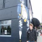 Captain Cook Tavern general manger Stu Munro stands by the student pub's new Captain Cook mural.