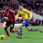 Cardiff City's Kevin Theophile-Catherine (L) challenges Arsenal's Aaron Ramsey. REUTERS/Rebecca...