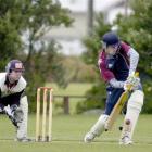 Carisbrook-Dunedin opening batsman James Hogg prods forward as Albion wicketkeeper Shaun Haig...