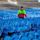 Carisbrook Rotary Project chairman Brendon Bearman stands among a stack of Carisbrook seats for...