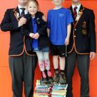 Carisbrook School, Dunedin, pupils Charlotte Roach and Lachie Wilden  stand on books given by...