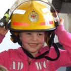 Carley McNee (4), from Wakatipu Kindergarten, tries on a firefighter's helmet.