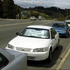 Cars for private sale parked on State Highway 87. Photo by Jane Dawber.