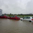Cars under water at the Avis depot at Dunedin International Airport on Saturday. Photo by Jolani...