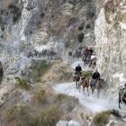 Otago Cavalcade riders pick their way around the narrow Dingleburn road, which is cut from a...