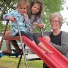 Central Otago Kindergarten Association manager Angela Jacobsen is joined by Neve (3, left) and...