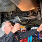 Centre City Auto Repairs owner Stephen Fraser inspects a vehicle for a warrant of fitness in...