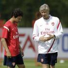 Cesc Fabregas, left, talks to Arsenal manager Arsene Wenger at a recent training session in...