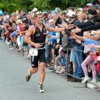 Challenge Wanaka winner Dylan McNeice  greets spectators as he approaches the finish line on...