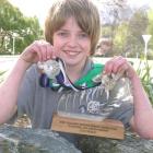 Champion sports climber Finn Fairbairn displays his recently won trophies and medals. Photo by...
