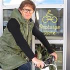 Charge About director Campbell Read with one of his eBikes at a charging station. Photo supplied.