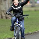 Charlie Simpson waves during his five mile cycle ride around South Park, west London, Sunday...