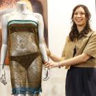 Charlotte Todd stands next to the dress she designed, and which was worn by Kate Middleton before...