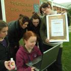 Checking their new website are the Tokomairiro High School Young Enterprise scheme members, from...
