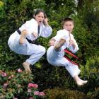 Cherie (left) and Ricky Jackson demonstrate some taekwondo moves at their home in Abbotsford...