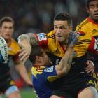 Chiefs Sonny Bill Williams offloads while held by Highlander Tamati Ellison at the Forsyth Barr...