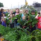Children from Strath-Taieri School celebrate last season's crop of vegetables at the Middlemarch...