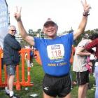 Ching-te Huang, of Taiwan, celebrates running his 106th marathon in as many weeks at the finish...