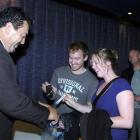 Chris Painter and Lisa Brown surrender their cellphones to Opel Security officer John Kena before...