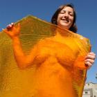 Christchurch artist Audrey Baldwin yesterday stands behind one of the panes of toffee that will...