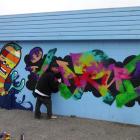 Christchurch graffiti artist Nick 'Icarus' Tam works on his 'fish and chips  graffiti' at the...
