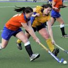 City Highlanders player Camille Keoghan (left) and Taieri's Olivia Smeele reach for the ball...