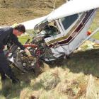 Civil Aviation Authority safety investigator Colin Grounsell, of Wellington, examines the...