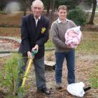 The oldest member of the Clark family, Ian Clark (78) plants a golden totara with the youngest...