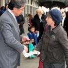 Dunedin Mayor Peter Chin receives the climate change relay baton and register of baton bearers...