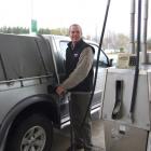 Clinton Community Company managing director John Cochrane fills his ute with the first tank of...