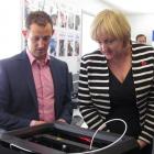 Communications Minister Amy Adams inspects  a 3-D printer with Richard Spackman from Heartland...