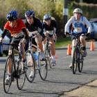 Competing in the cycling leg are (from left) Hamish McKay (Dunstan), Millie Gordon (St Hilda's),...