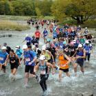 Competitors  cross the river at Arrowtown in last year's Motatapu event. Photo by Stephen Jaquiery.