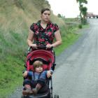 Concerned mother Amanda Duthie pushes her son Michael (2) down Kilgour St, Waihola. Photo by...
